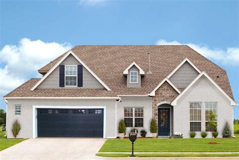 tan brick house with blue facia boards and metal roof|light tan house colors.